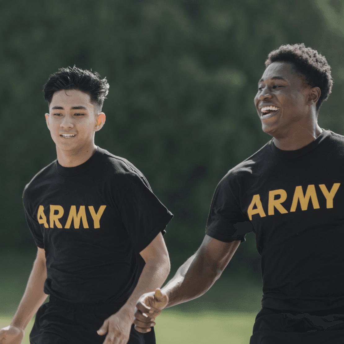 Two smiling soldiers running during Army physical training