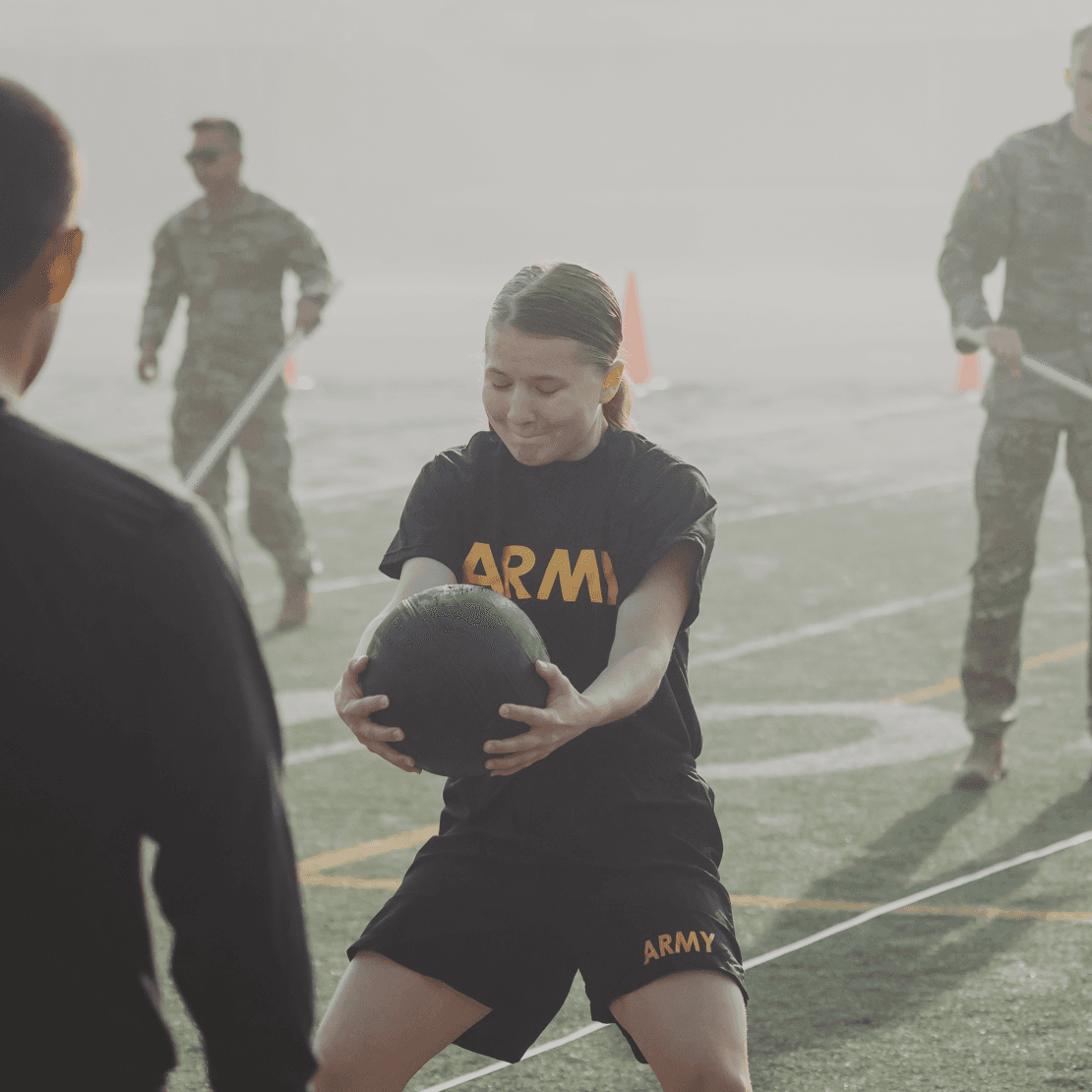 Female soldier catching a medicine ball in the Standing Power Throw